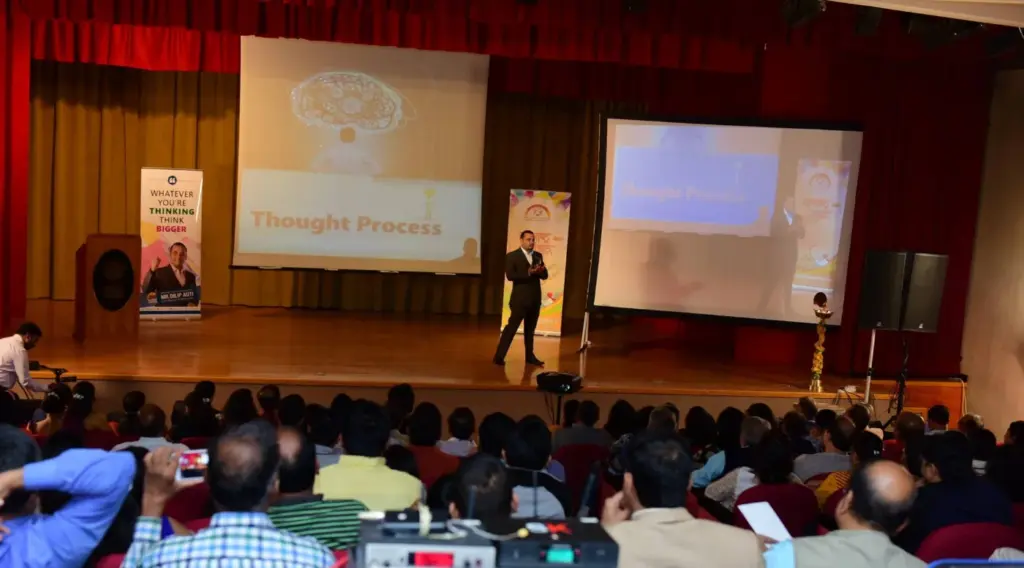 Addressing a full hall of business owners